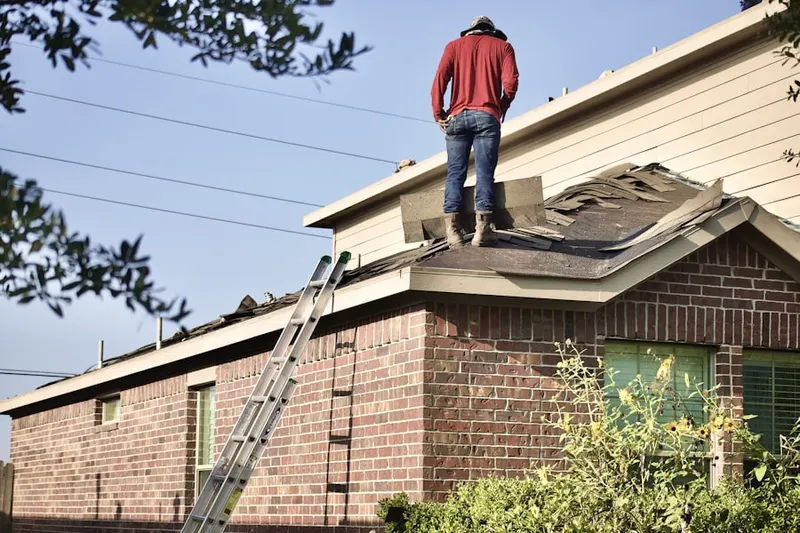 Professional roofer working on a residential roof in Columbus Park